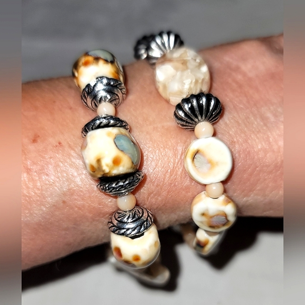 Neutral color two stretch bracelets and earrings.